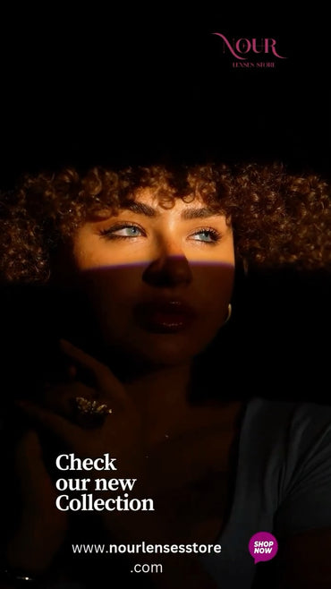 Woman with curly hair looking into a mirror with 'Nour' brand visible.