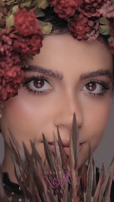 Woman with floral headpiece and 'L'Ness Noir' store logo