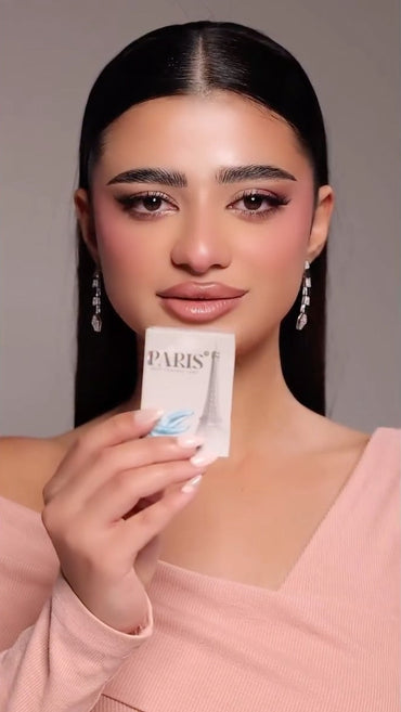 Woman holding a product packaging with a neutral background