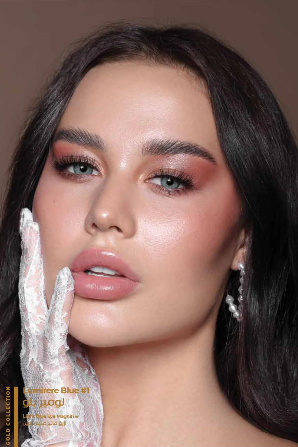 Close-up of a model with makeup and jewelry, with a brand logo in the corner.